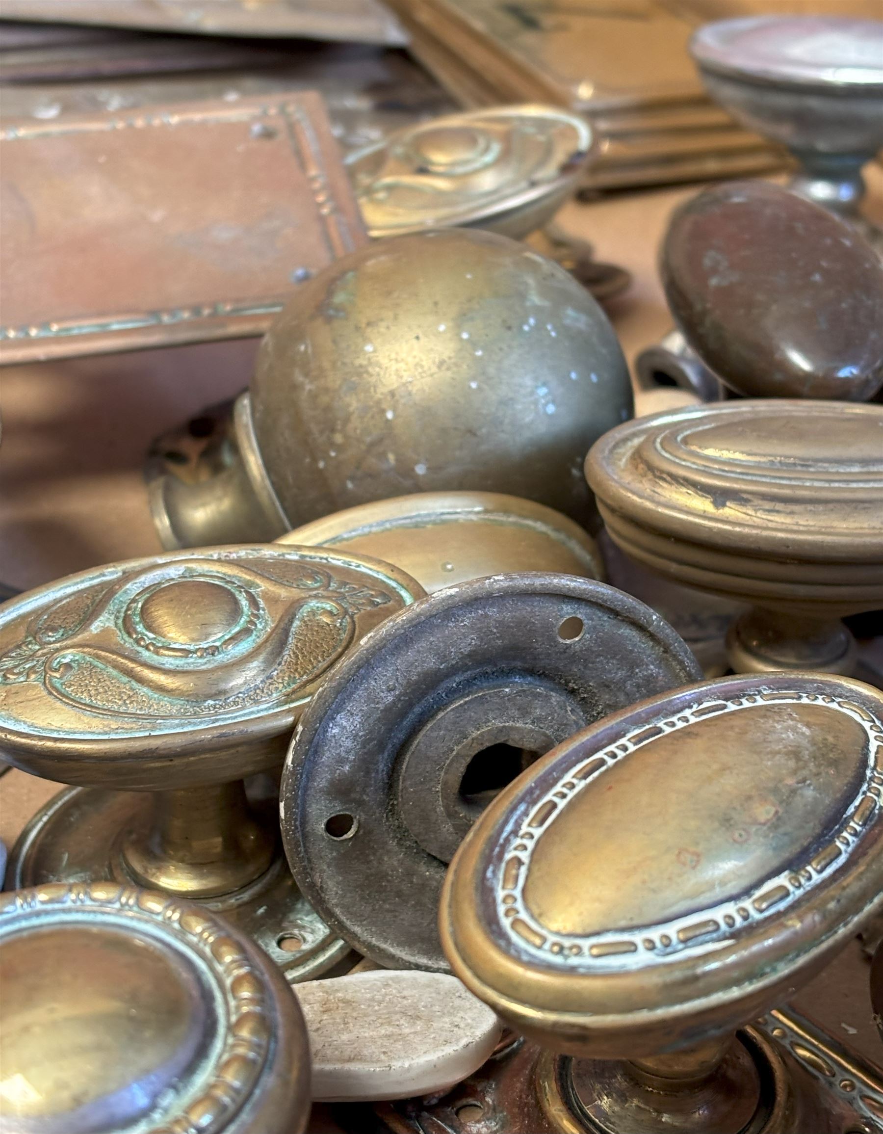 Collection of mainly early 20th century door furniture, to include Art Nouveau brass finger plates, brass door pulls and knobs, ceramic escutcheons and latches, together with other antique hardware. (some later)  - COLLECTION BY APPOINTMENT FROM: The White House, Thirsk Road, Easingwold, York, YO61 3NF - CALL 01723 507111 TO ARRANGE