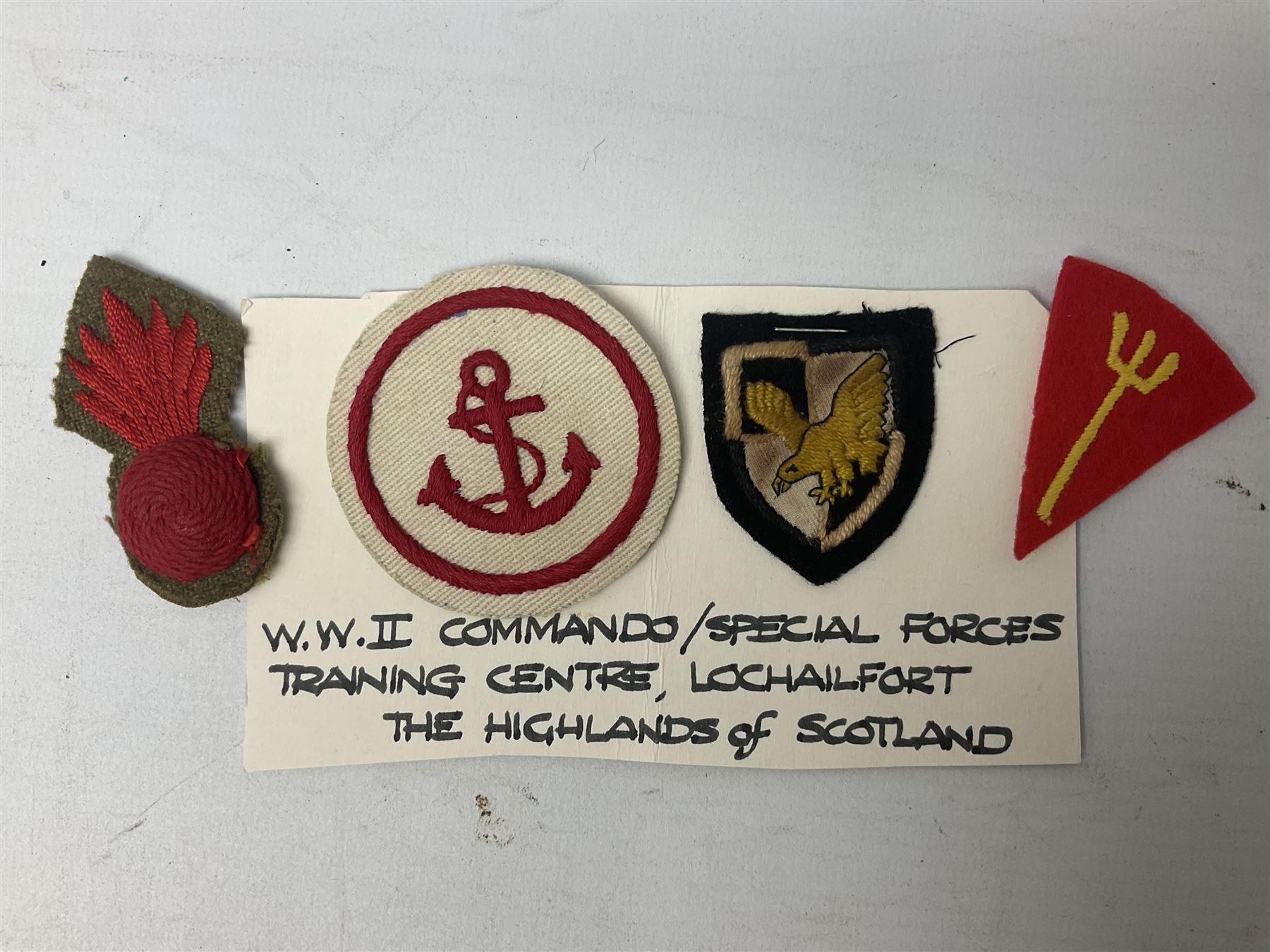 Royal Arms cloth arm adge as worn by Regimental Serjeant-Majors in Foot Guards; naval cap badge; WW2 Commando/Special Forces cloth badges; Home Guard and LDV shoulder titles; and other cloth badges including armoured division, 45th and 77th division, 52nd Lowland Mountain division etc; and 24th Infantry Brigade airmobile pennant