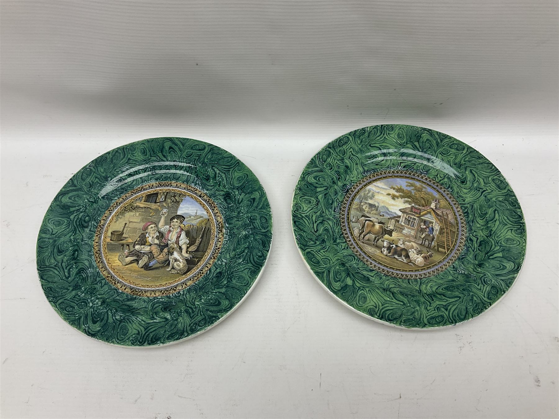 19th century Prattware table ware to include an oval footed dish decorated with a scene after Landseer 'Highland Music', retailed by James Muggleton L27.5cm, ‘The Truant’ plate after T. Webster, 'Blind Man's Buff' & 'Snap Dragon' tea plate, two side plates with malachite printed borders and others (17)