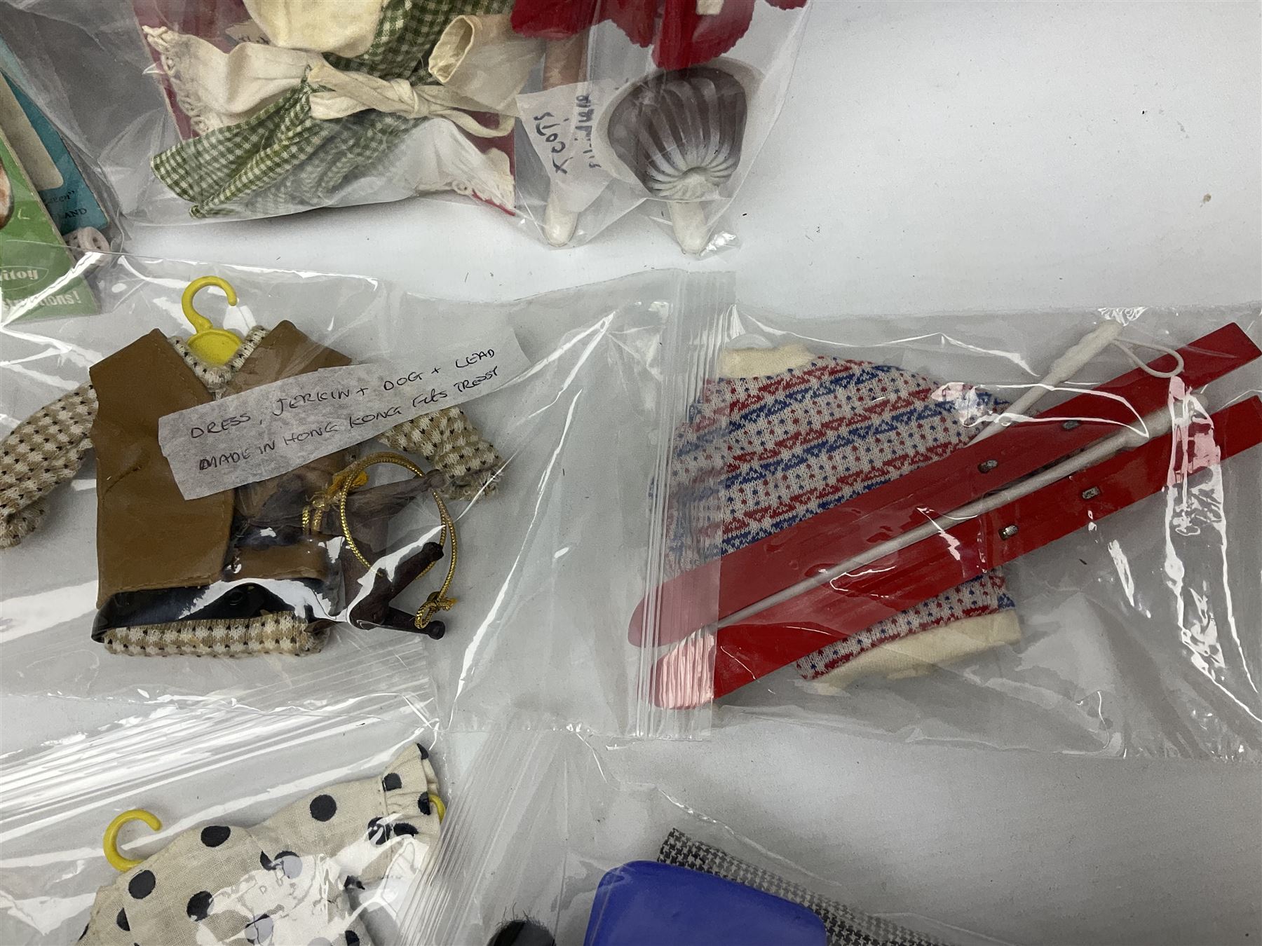 1960s Palitoy Tressy fashion doll, boxed with stand and booklets; four additional Tressy outfits (In The Office, Winter Journey, Winter Sports and Evening Date); two other outfits; and Tressy's Little Sister Toots doll with Style Book and additional outfit