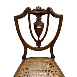 Pair of Regency rosewood framed side chairs, carved back rails over cane seat, raised on reeded supports (W46cm D50cm H84cm); set of three Edwardian walnut cane seat bedroom chairs, carved shield back (W41cm H88cm)