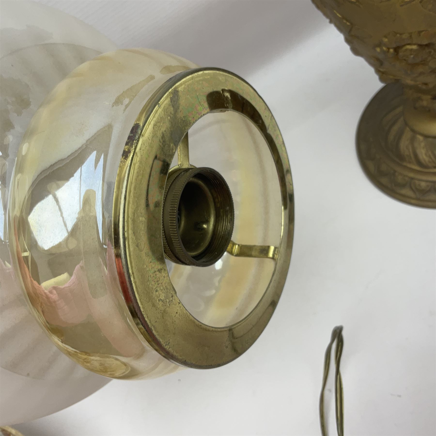 Gilt metal table lamp, heavily embossed with flowers and butterflies, with fluted frosted glass shade, H56cm