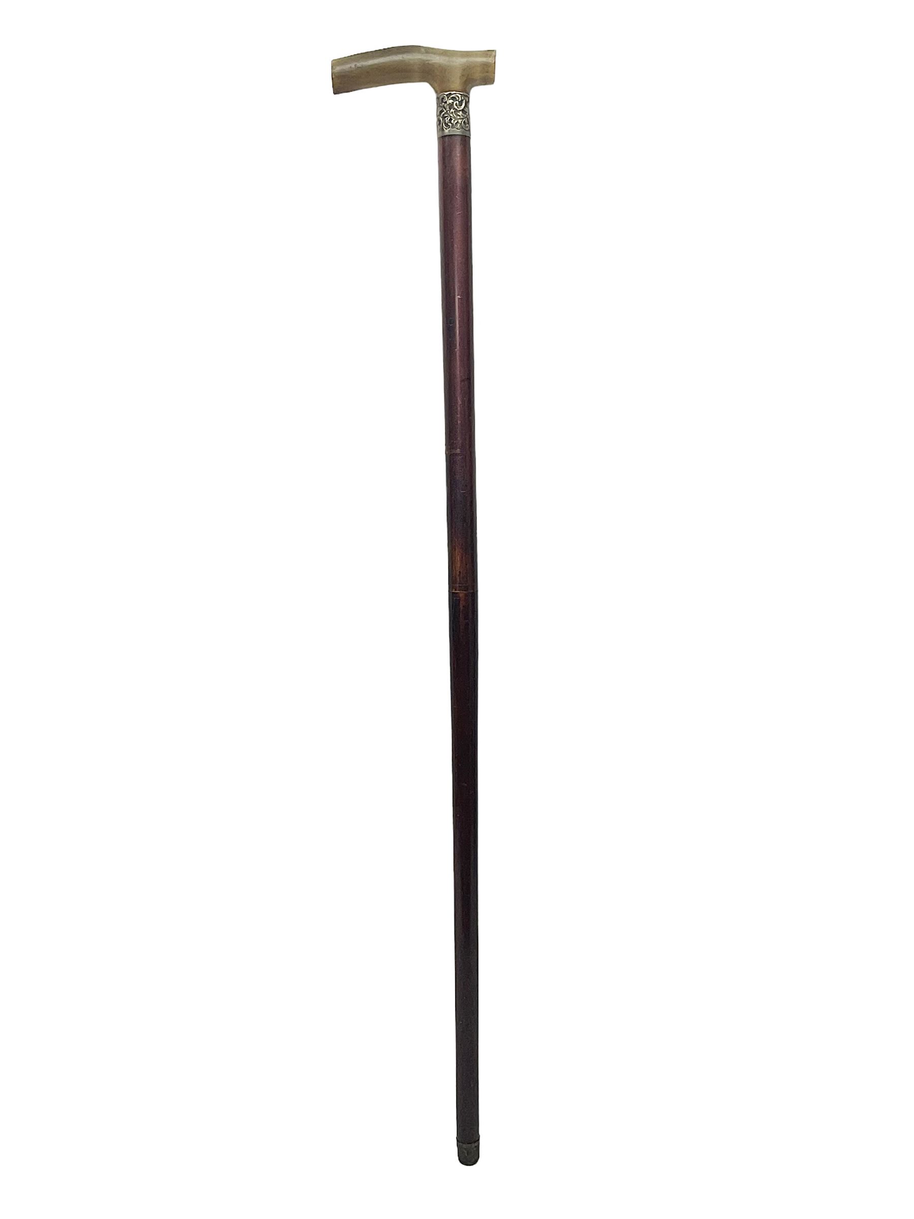 Victorian magician's cane, the mahogany walking stick twisting apart to reveal an internal mechanism, opening to tripod and black silk fold out magician's table, with horn handle and silver mount, hallmarked Birmingham 1891