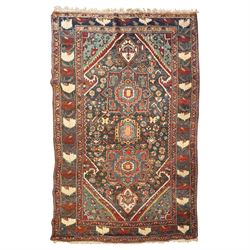 Antique Persian Qashqai dark indigo ground tribal rug, the busy field decorated with a geometric triple pole medallion surrounded by numerous stylised plant motifs with contrasting cyan spandrels, the multiple guard bands woven with stylised palmettes and foliage