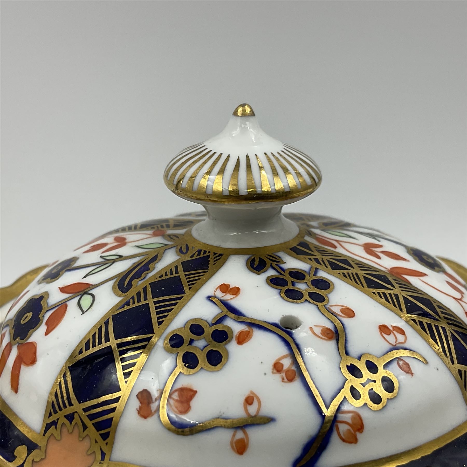 Early 20th century Royal Crown Derby teapot, decorated in a variant of the Imari pattern with blue and red prunus blossoms, with printed mark beneath including illustration date code for 1927, H14cm
