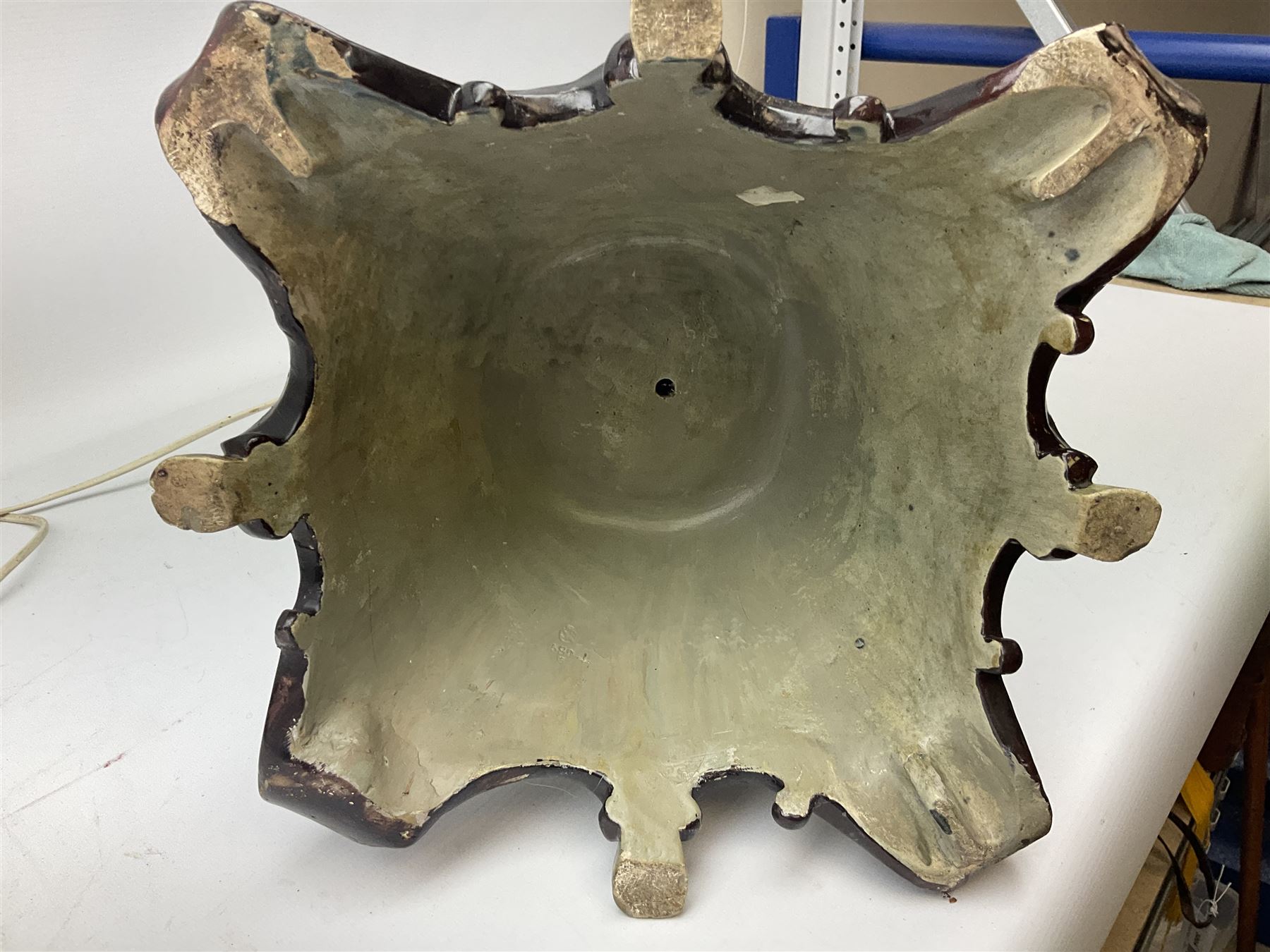 Composite table lamp modelled as a Roman Emperor donning blue robes, upon quatrefoil base modelled with rams heads and winged cherubs, H56cm excl fitting