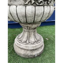 Stone effect campana shaped garden urn/planter, the body decorated in relief with cherubs and scrolls, planted  - THIS LOT IS TO BE COLLECTED BY APPOINTMENT FROM DUGGLEBY STORAGE, GREAT HILL, EASTFIELD, SCARBOROUGH, YO11 3TX