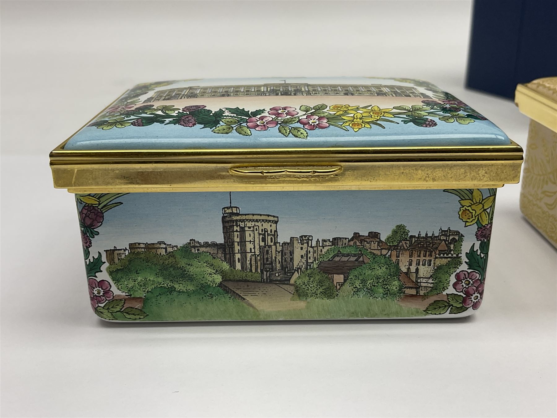 Two Halcyon Days enamel boxes, both of rectangular form, the first depicting Buckingham Palace, 'To Celebrate the Golden Jubilee of Her Majesty Queen Elizabeth', the second depicting the marriage of The Queen and Prince Philip, in celebration of their Diamond Wedding Anniversary, H4cm, W8.5cm, both boxed