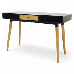 Modern black single drawer desk, black rectangular top above a single oak veneered drawer with black metal pull, flanked by two open shelves raised on tapering oak veneer legs (From floor to underside 64cm)