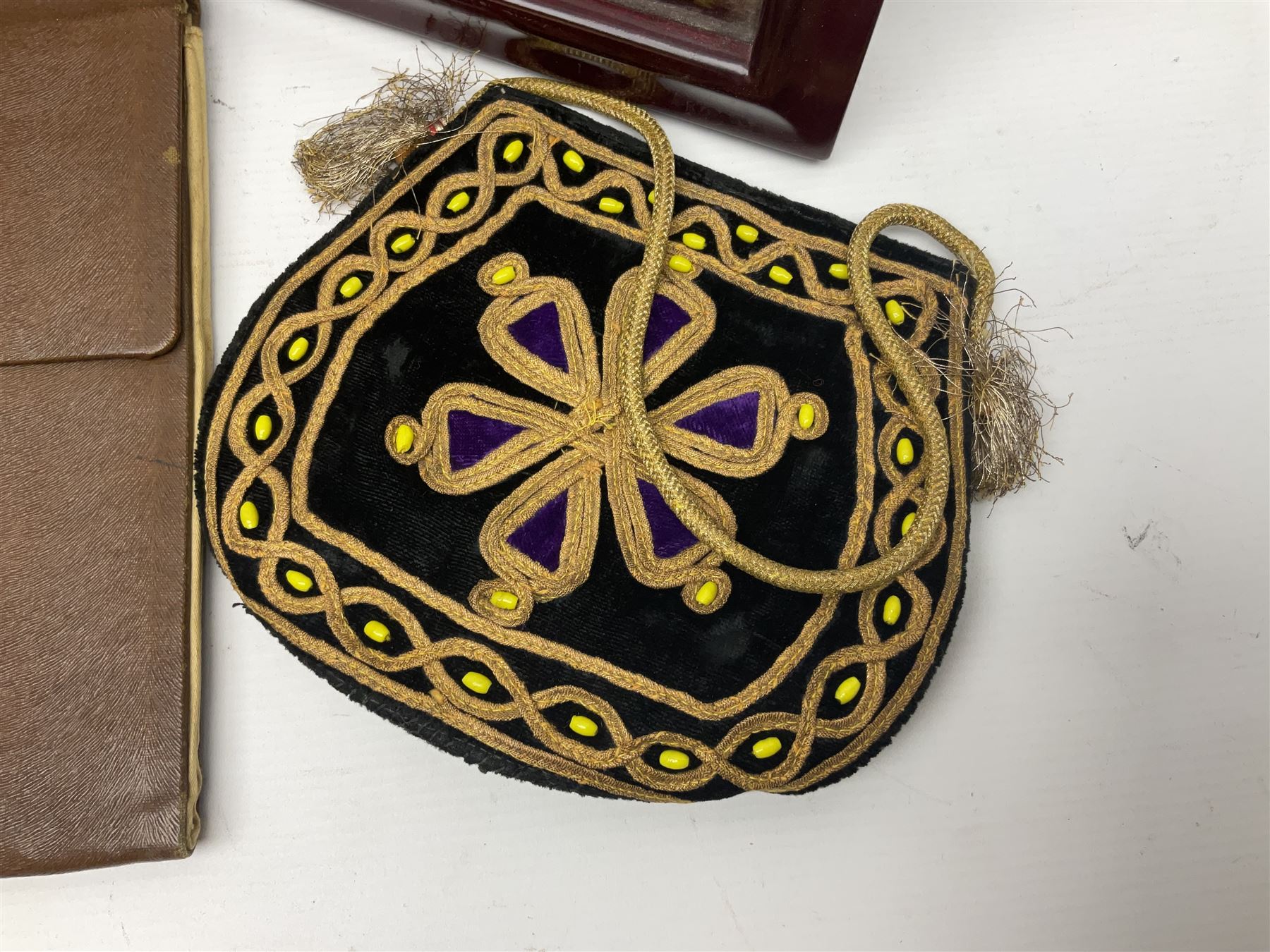 Continental petit point evening bag, with enamel and pearl details, in wooden display frame, together with a snake skin handbag and three other vintage bags