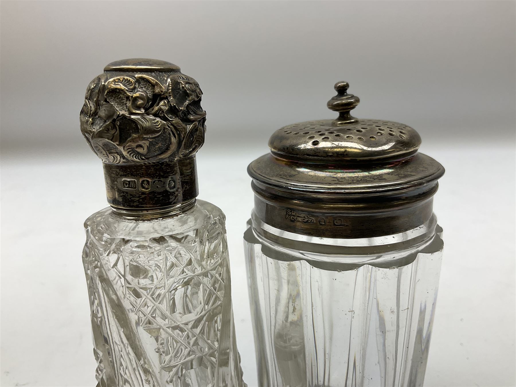 Edwardian silver mounted purse, with circular panel engraved with initials, and hammered finish, hallmarked William Comyns & Sons, London 1903, H14cm, together with three dressing table glass jars with hallmarked silver covers, and a hallmarked silver mounted buffer 