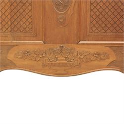 Early 20th century French oak double bedstead, the shaped and moulded headboard carved with central floral cartouche and scrolling foliage above lattice carved panels, the conforming footboard with pierced and carved decoration, shaped apron with foliate carving, raised upon cabriole supports