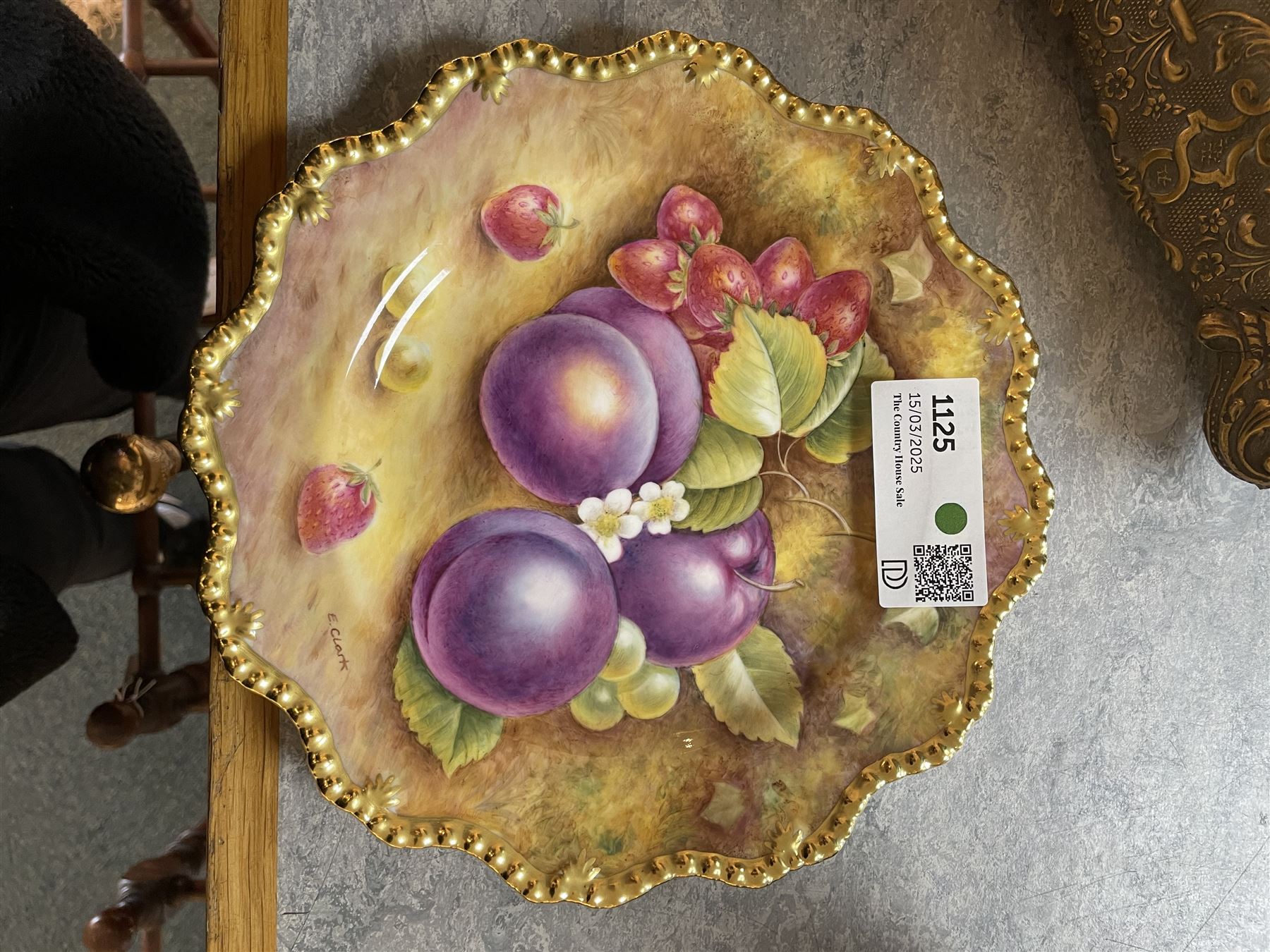Late 20th century Royal Worcester star plate, of circular form with shaped with gilt shaped rim, hand painted by E Clark with still life of fruit upon mossy ground, signed E Clarke, with marks beneath including limited edition no 28/100, with makers fitted card box, D23cm
