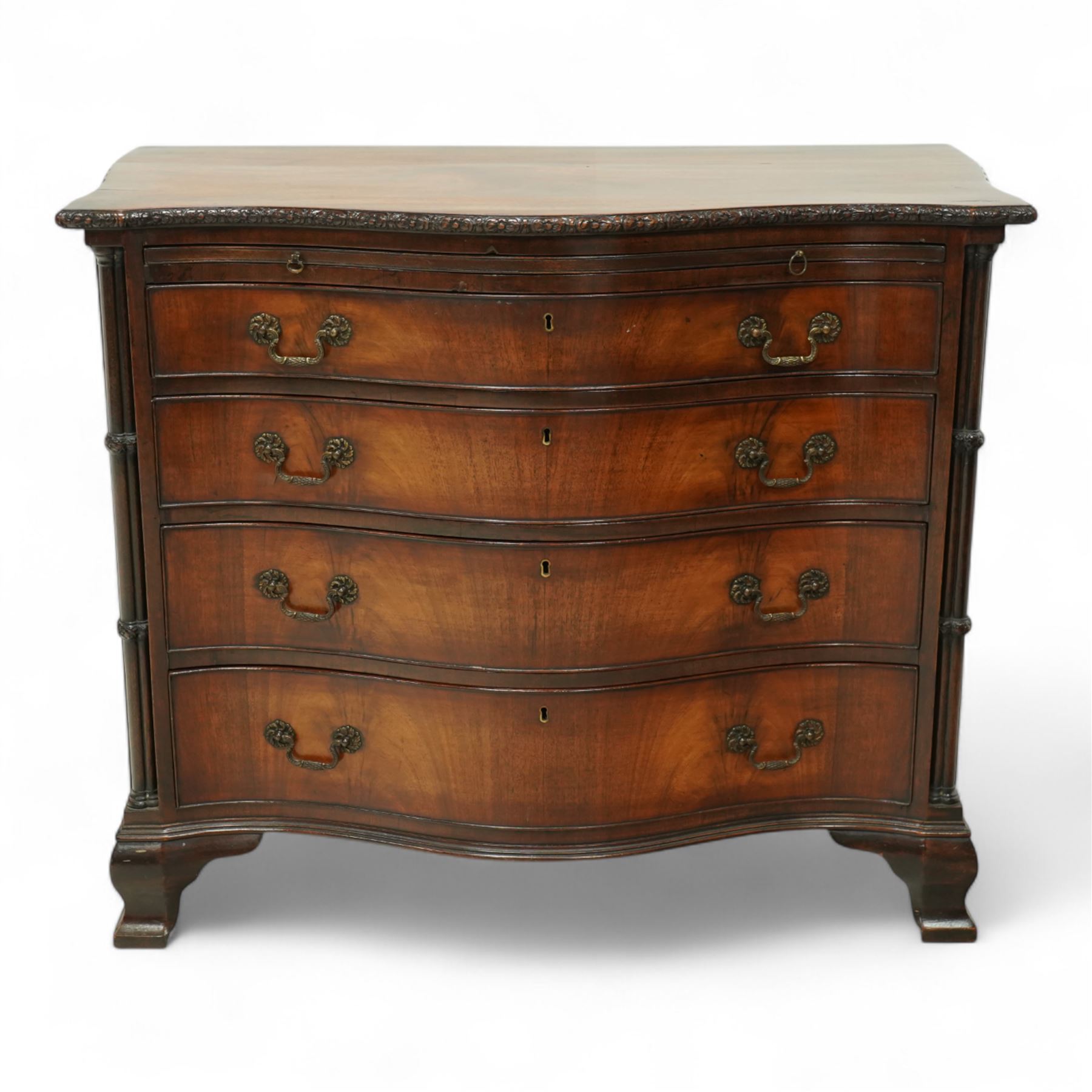 Georgian design mahogany serpentine chest, with rectangular top with floral rosette carved edge, cluster reeded columns with brush slide above four graduated drawers on ogee bracket feet 