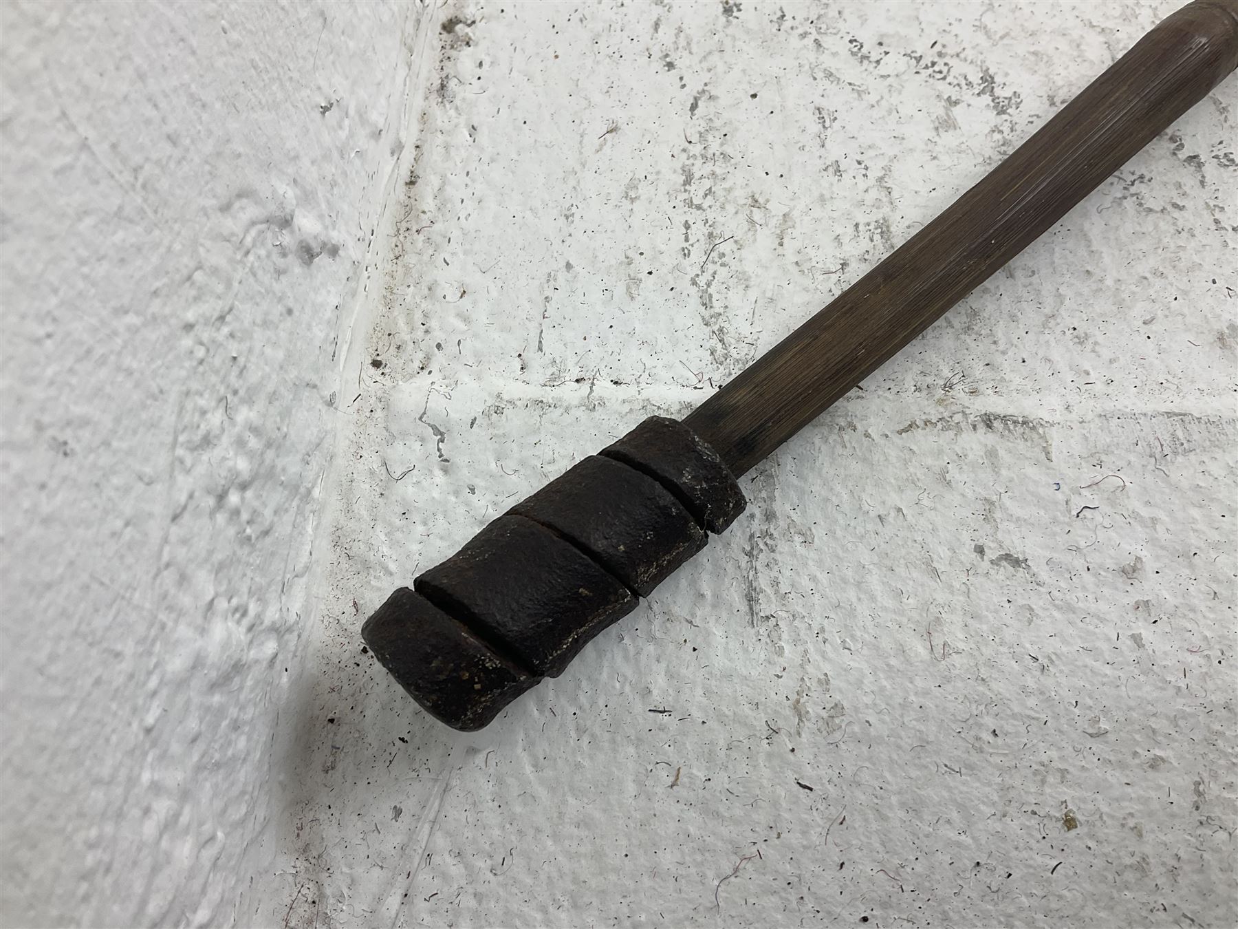 Native long-shafted spear, the large iron head with central medial ridge and decorative neck, on plain circular haft L260cm; and another similar Native long-shafted spear with cane haft L249cm (2)