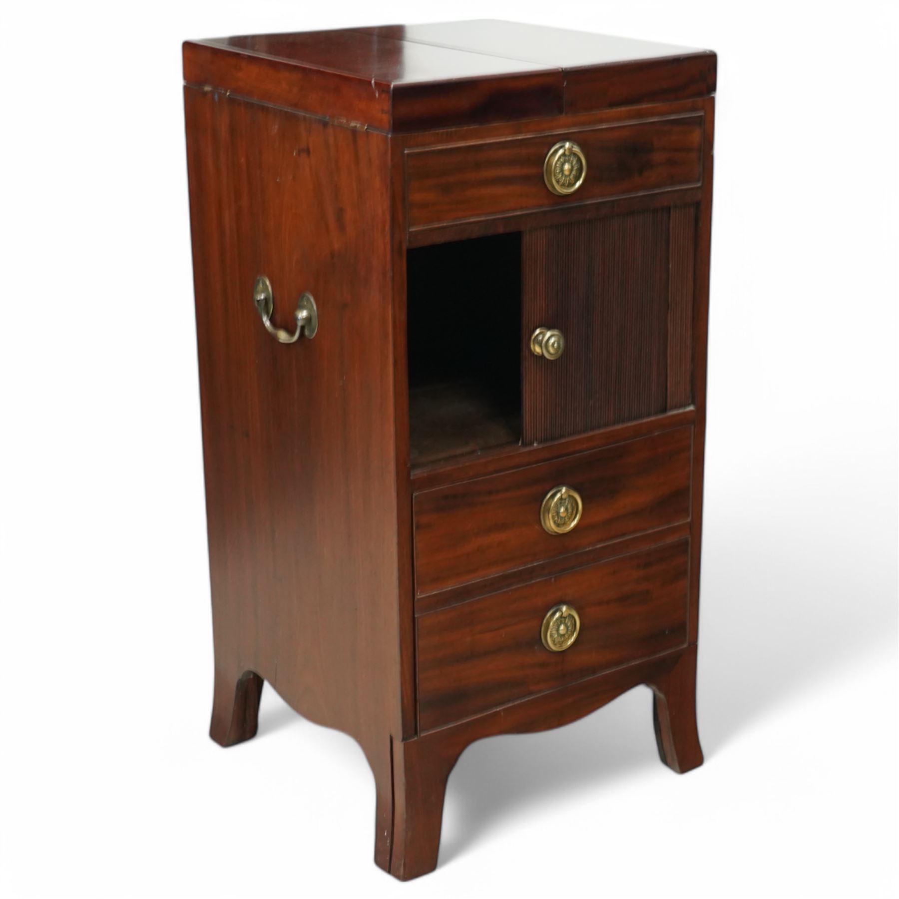 Early 19th century and later mahogany washstand, the dual-hinged fold-out top, over a cupboard enclosed by tambour roll, fitted with deep drawer to base disguised as two cock-beaded drawers, on splayed supports