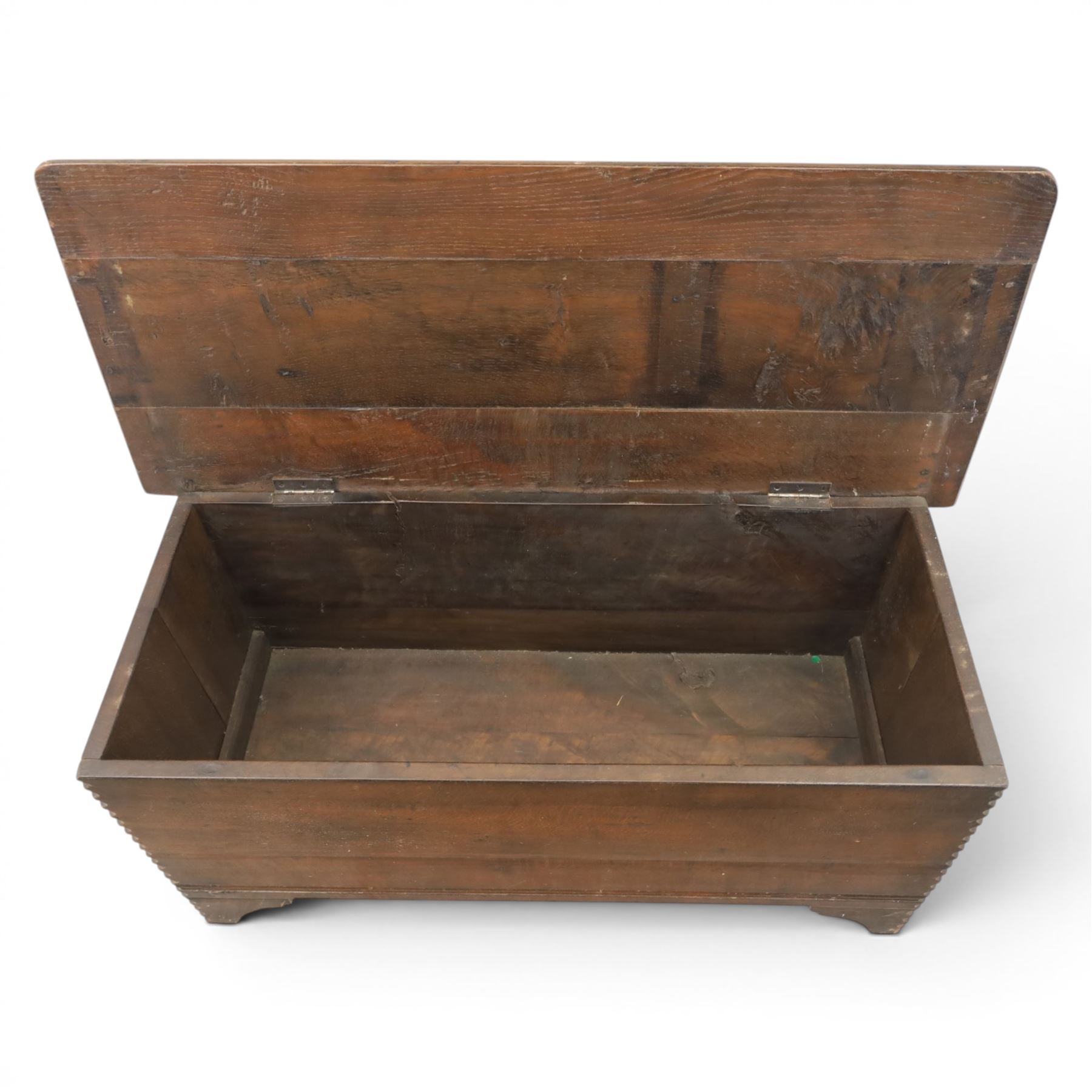 19th century oak boarded blanket box, with chip-carved edges, raised on shaped cut away bracket supports