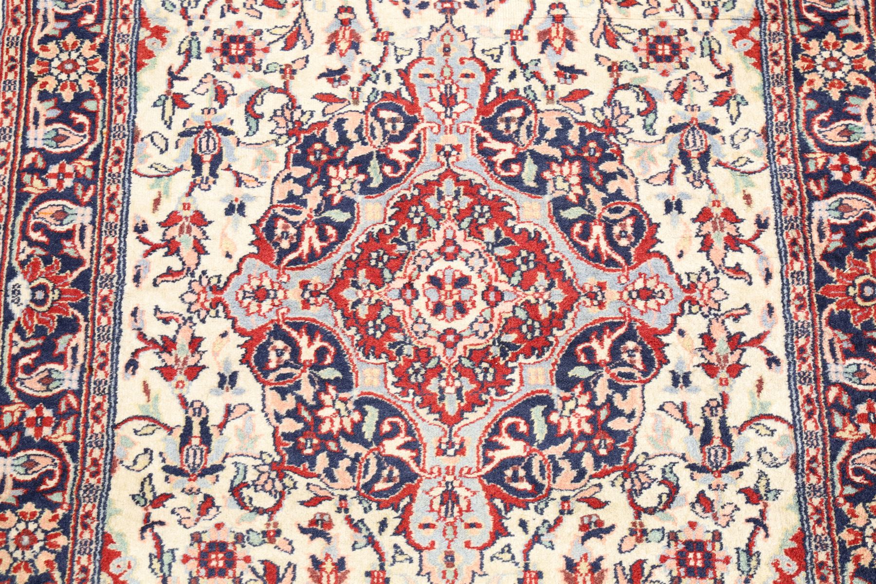 Two Persian rugs, Persian Hamadan hand-knotted rug, ivory ground centred by a terracotta medallion, surrounded by scrolling floral and foliate motifs, dark navy floral border with narrow guard stripes, fringed ends, H 176cm, W 75cm, Persian tribal hand-knotted rug, madder red ground decorated with three large geometric medallions, surrounded by angular motifs, enclosed by multiple geometric borders in dark navy, ivory and red, fringed ends, H 150cm, W 91cm