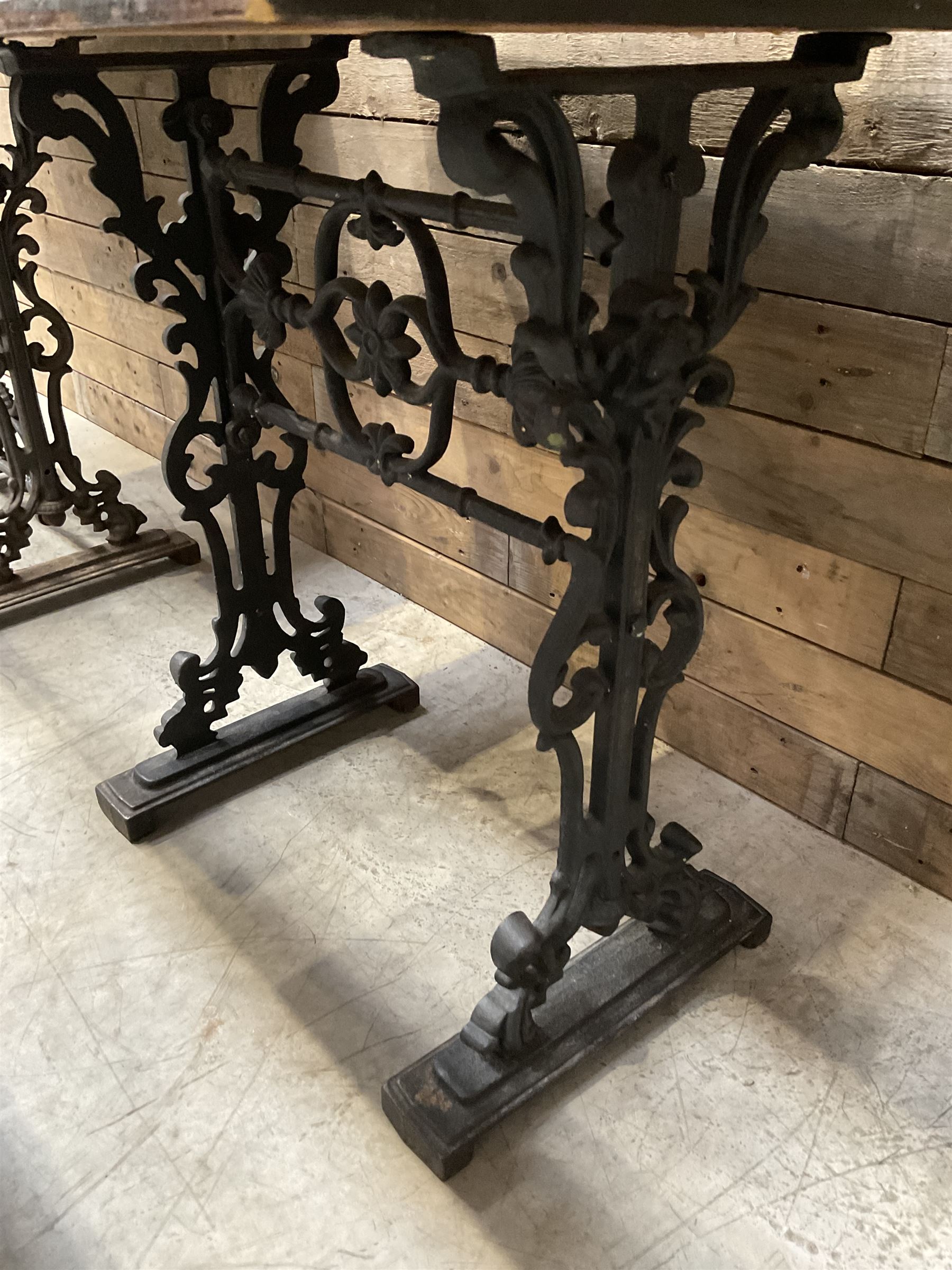 Four cast iron pub or bar tables with rectangular tops