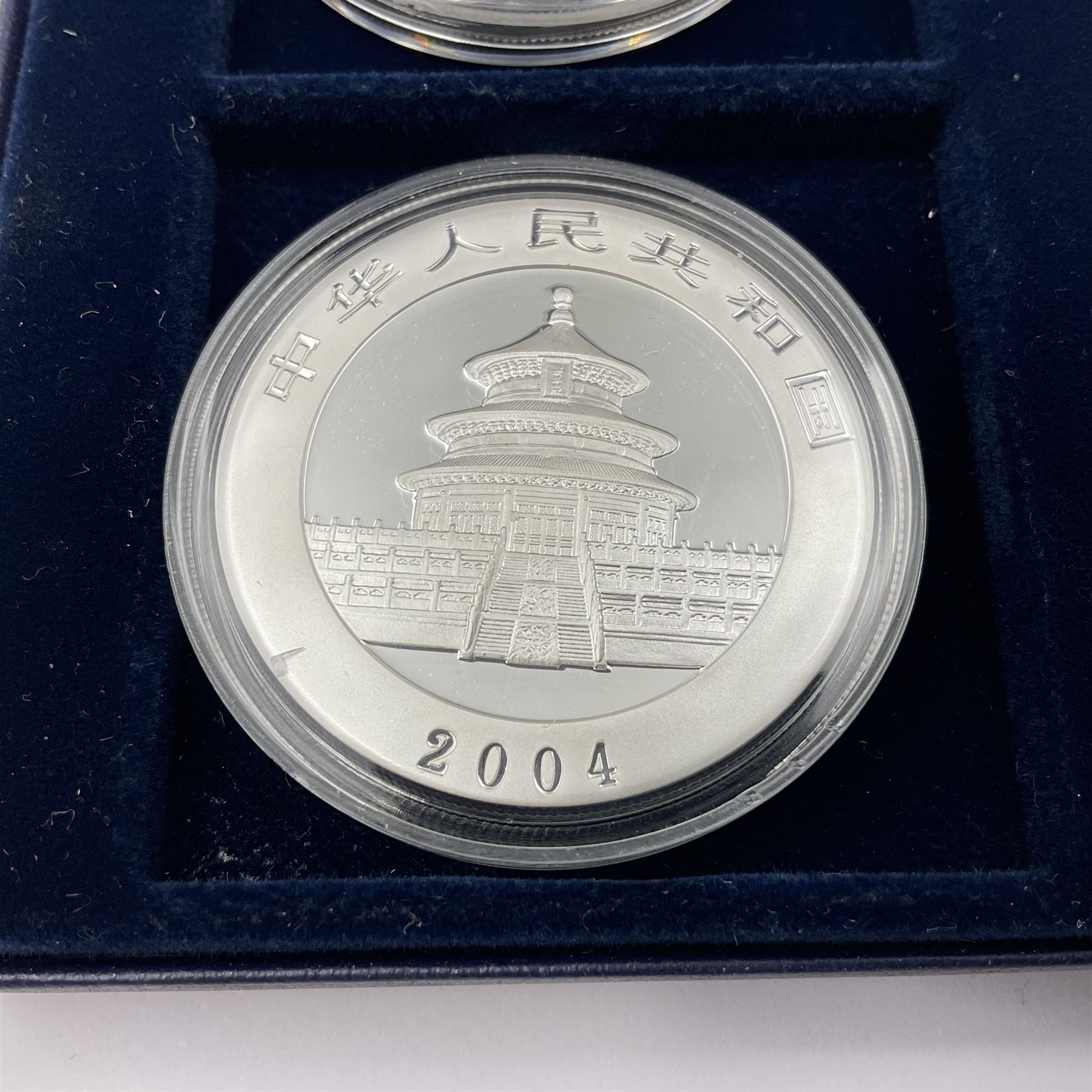 Four one ounce fine silver coins, forming 'The 2004 Famous World Silver Coin Collection', comprising United States eagle, Australian kangaroo, Chinese panda and Canadian maple leaf, cased with Westminster certificate 