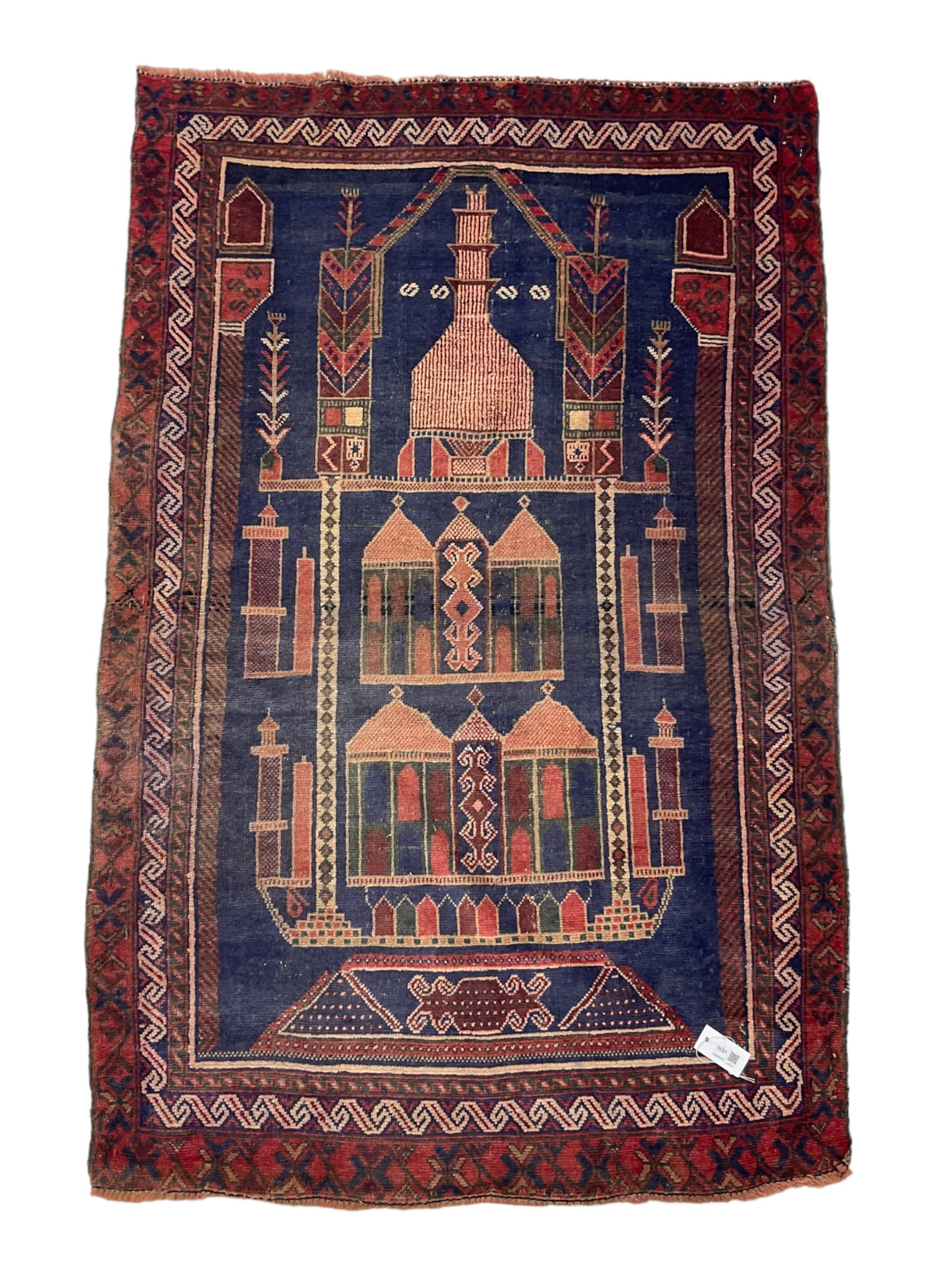 Persian Baluchi prayer rug, blue ground field decorated with Mosque and cityscape, the border with repeating geometric designs 
