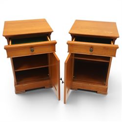 St Michael - pair of cherrywood bedside tables, single drawer above a fielded panel door, brass pulls, raised on a plinth base