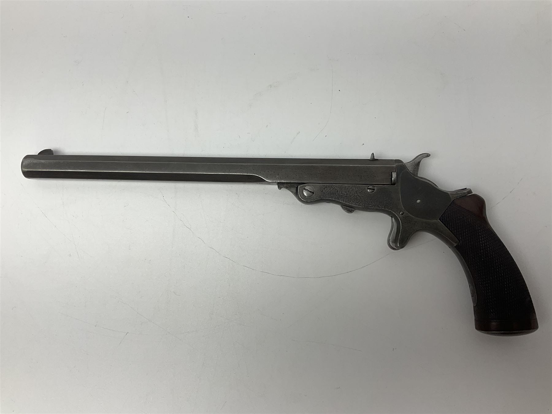 19th century .297/230 rimfire single shot break-action pistol, ''Tranter's Patent'', no.2;  the 25cm octagonal barrel marked Kynoch Gun Factory Aston; fin fore-sight, dove-tail standing notch rear-sight, open iron frame with barrel release button to the integral fore-end, central hammer, spur trigger and chequered walnut one-piece grip with domed iron pommel-cap L36cm overall