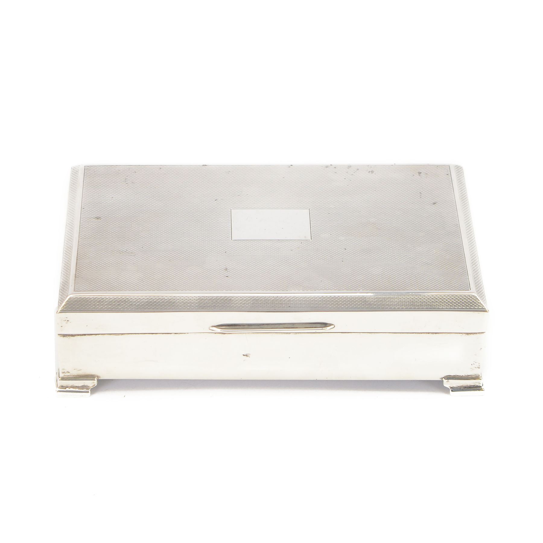 Mid 20th century silver mounted cigarette box, of rectangular form with engine turned decoration to the hinged cover, with vacant rectangular cartouche, opening to reveal a compartmentalised softwood interior, upon four bracket feet, hallmarked Henry Clifford Davis, Birmingham 1964, H4cm, W15cm