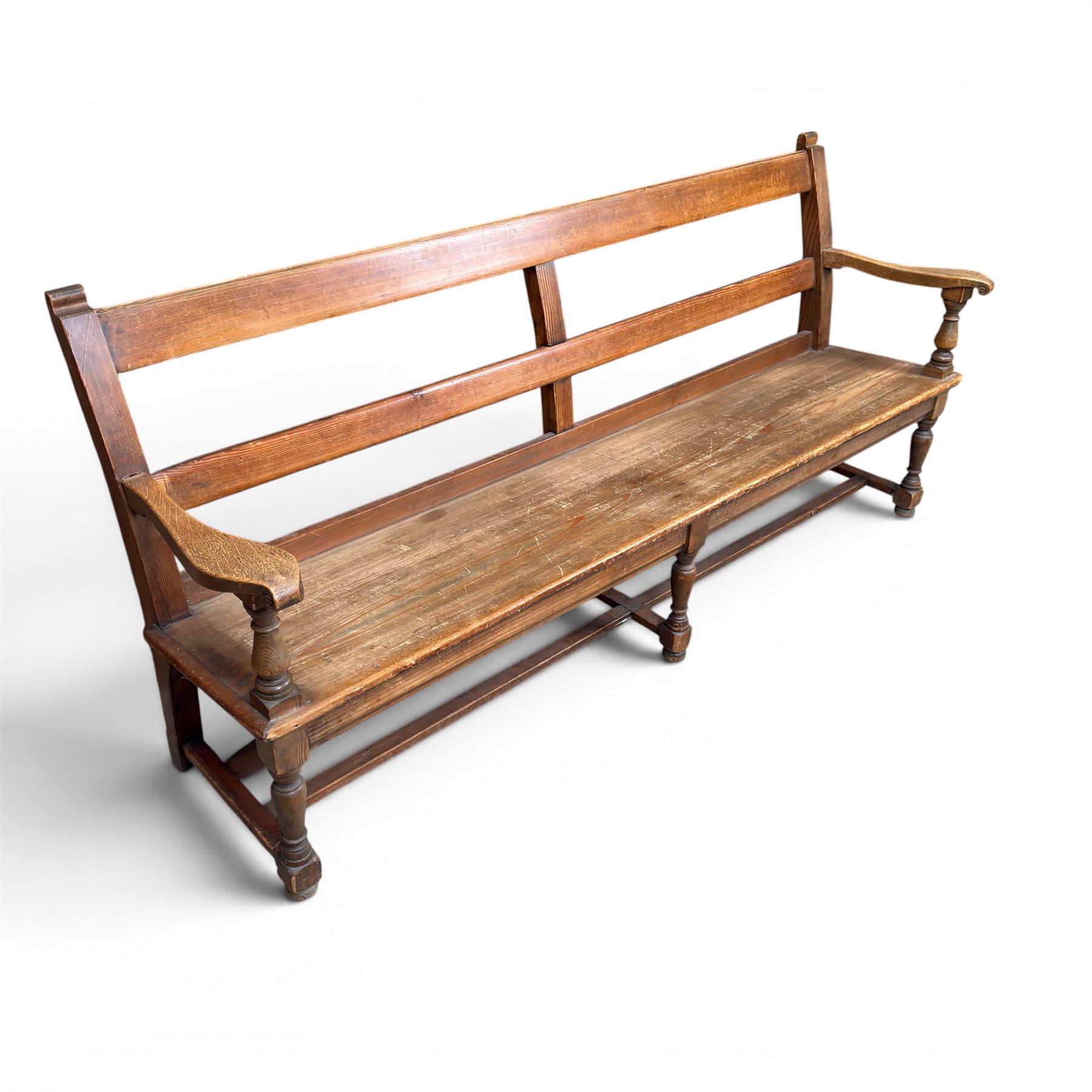 Early 20th century pine and oak bench seat, stained pine rail back frame with shaped oak arms