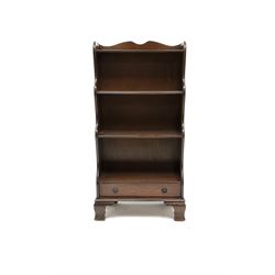Mid to late century mahogany three tier open waterfall bookcase, single drawer, shaped bracket supports 