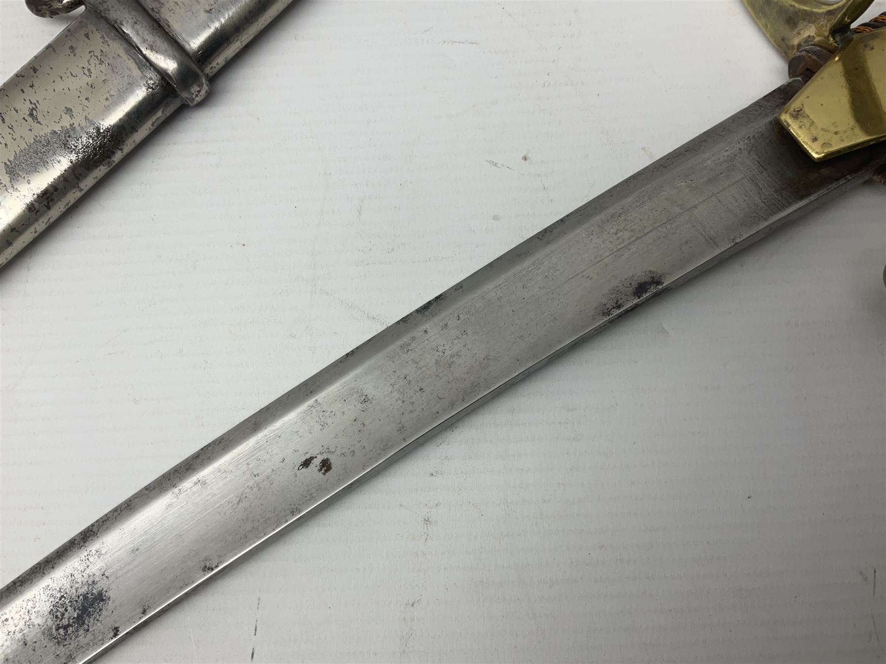 19th century Russian Imperial Navy sword, with 77.5cm curving fullered blade, brass three-bar hilt with lozenge shaped langets and wire-bound leather grip; in polished steel scabbard with one suspension ring L97cm overall