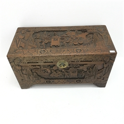 Eastern camphor wood chest, heavily carved depicting figure being carried in a sedan chair, hinged lid, W89cm, H49cm, D43cm