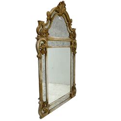 Victorian design parcel gilt wall mirror, shaped cresting with foliate cartouche pediment, decorated with C-scrolls and scrolled foliage, moulded frame with segmented mirror plates