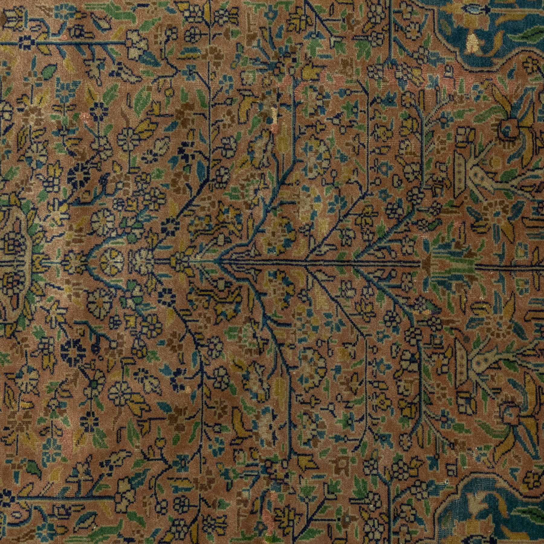 Antique Persian rug, with central tree of life design on a camel field, enclosed by dark blue floral border, with green, blue and ochre detail throughout