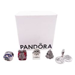 Five silver Pandora charms including Pandora shopping bag, Christmas tree, wrapped present, Winter scene, and snowman with reindeer droplet charm, all stamped S925 ALE, with one Pandora box 