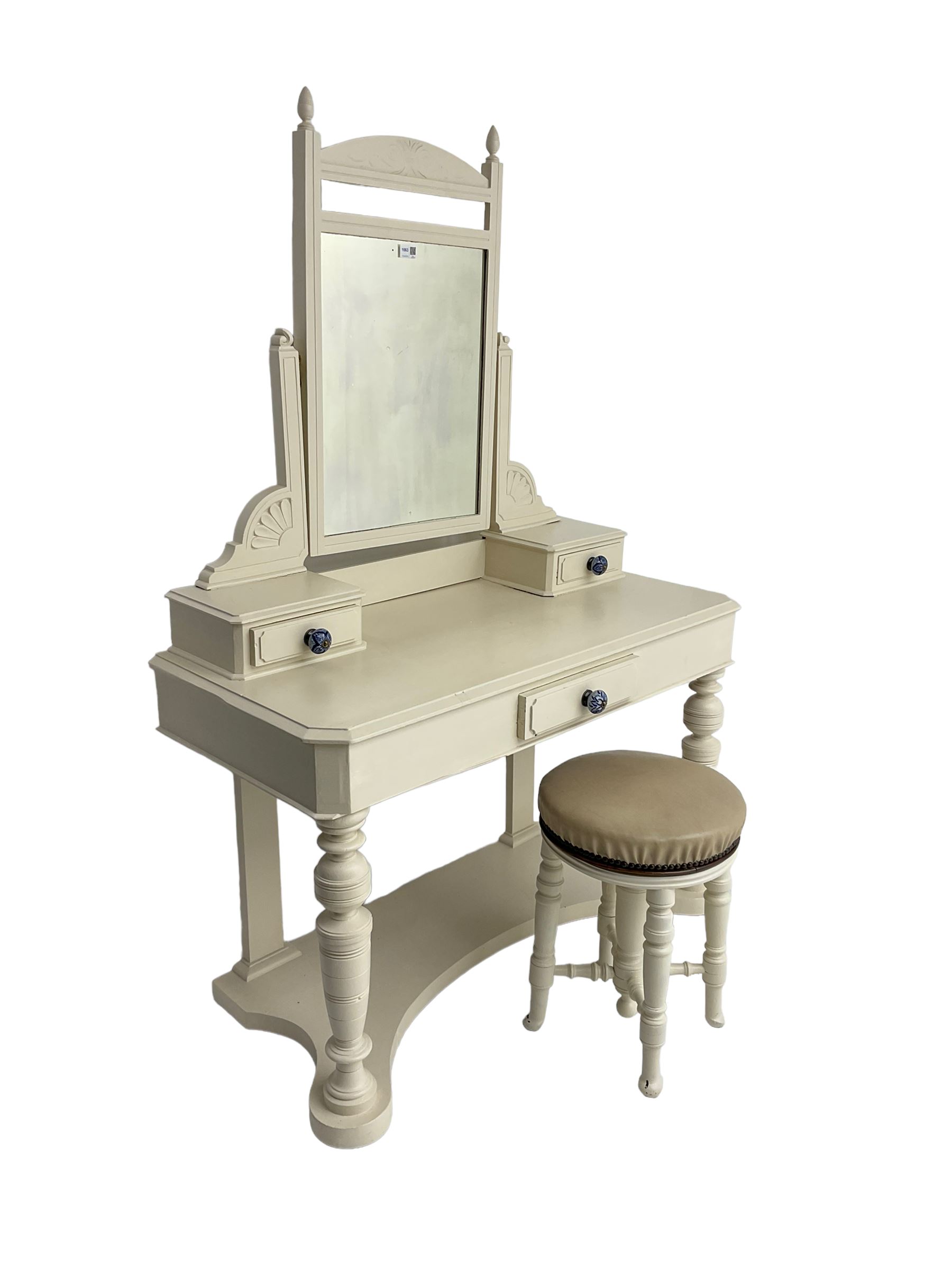 Edwardian cream painted dressing table, fitted with rectangular swing mirror over two trinket drawers with ceramic handles, rectangular top with frieze drawer, raised on turned front supports; with circular stool, leather seat over four turned supports