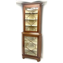 Early/mid century mahogany corner display cabinet, projecting cornice above two astragal glazed doors, enclosing lined interior with five shelves, shaped bracket supports 