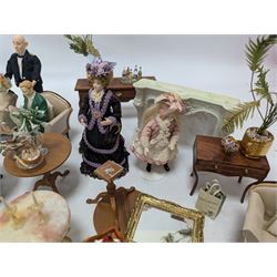 Dolls house furniture, including sofa, chairs, foot stools, fireplace, sideboards, five figures, mirrors, paintings and accessories