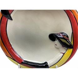 Lorna Bailey Old Ellgreave Pottery, comprising teapot in beach design, circular jar in house and path design, shell jug in Bridge and stream design, squat jug in Pagoda design and plate decorated with an Art Deco woman, all with printed and painted marks. 