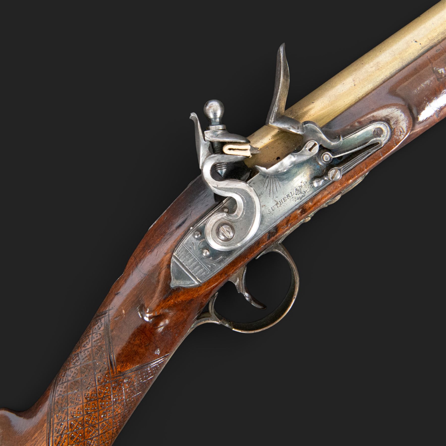 English flintlock blunderbuss, circa 1780 by R. Sutherland of London, the 32cm brass barrel with proof marks and London to the top, with original ramrod with brass tip below, the lock engraved Sutherland, walnut stock with brass butt plate, steel trigger guard with acorn finial, overall L70cm  
