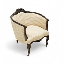 Victorian carved mahogany tub chair, upholstered in cream patterned fabric, with pierced foliate carved top rail, curved back and seat, serpentine seat rail, on cabriole front legs with brass castors