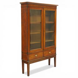 19th century mahogany enclosed bookcase on stand, projecting cornice and banded frieze ove...