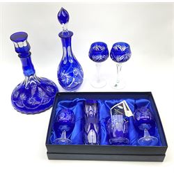 A selection of Bohemian style blue flashed glass, comprising ships decanter and stopper, further decanter and stopper, pair of hock glasses, further pair of smaller hock type glasses, pair of tumblers, and further tumbler. 