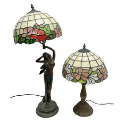 Tiffany style lamp in the form of a semi nude woman holding up a leaded lampshade together with a similar table lamp