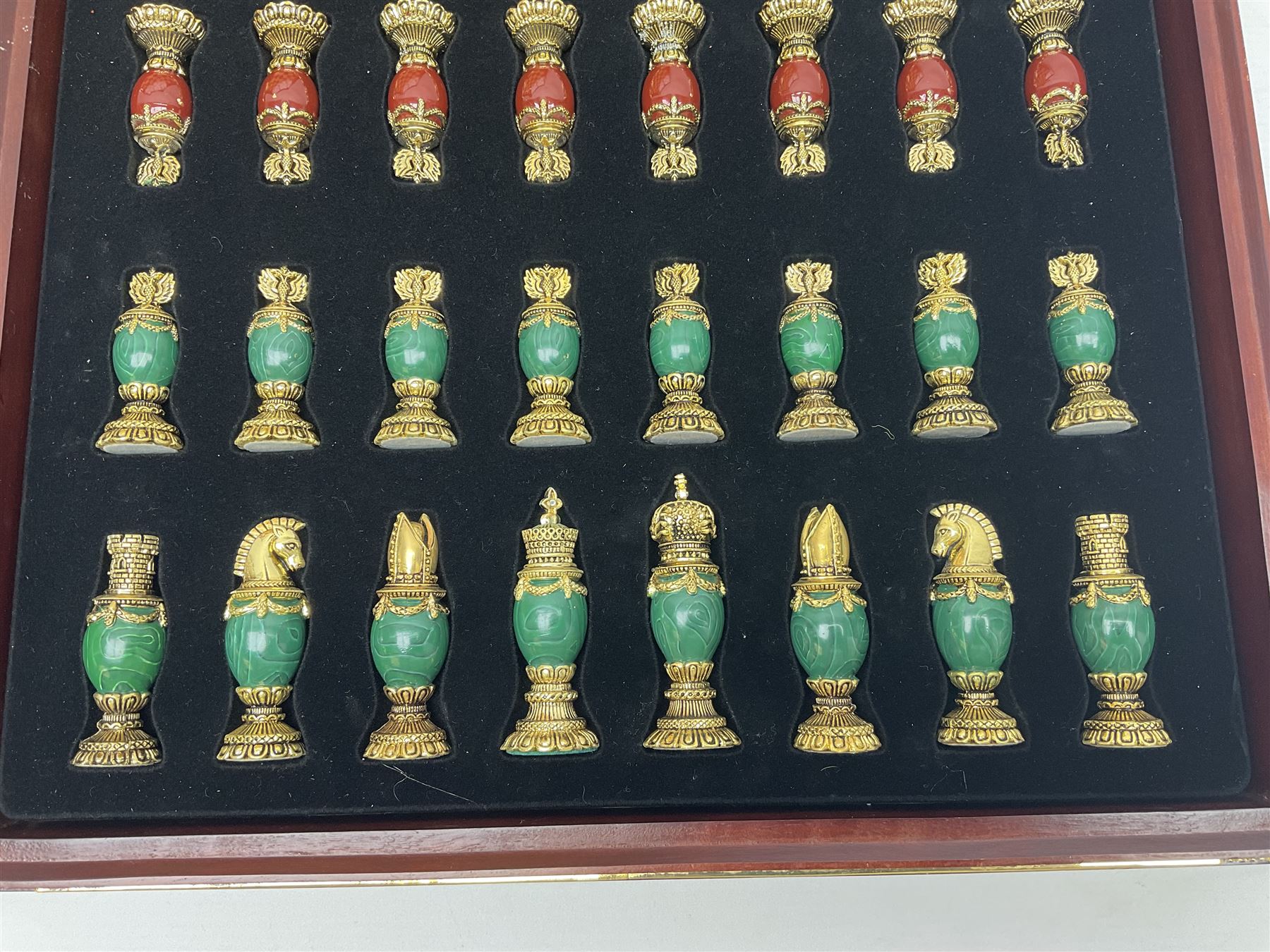 Franklin Mint House of Faberge 'The Imperial Jewelled Chess Set', to include set of chess pieces with malachite finish and a set with carnelian finish and a hardwood chess board