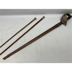 George V 1897 pattern Army Officer's sword by Henry Wilkinson Pall Mall London, the 82.5cm 'London Made' blade etched to both sides with Royal Crests and cyphers etc, pierced half-basket hilt with wire-bound fish skin grip and remains of leather knot strap; in leather covered field service scabbard L101cm overall; and two 14th Prince of Wales Own swagger sticks (3)