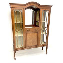 Edwardian inlaid mahogany display cabinet with ‘Shepard, Bennington &Co, Doncaster’ makers plaque, central bevel edge mirror flanked by two glazed doors enclosing two lined shelves, single drawer above cupboard on square tapering supports with spade feet