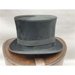 Early 20th century black silk top hat by Woodrow of Manchester and London, with manufacturer's stamp to the silk lined interior, housed in fitted tan leather hat box with removable internal compartments with straps, brass escutcheon and engraved plaque, hat internal measurements approx 20cm x 15cm