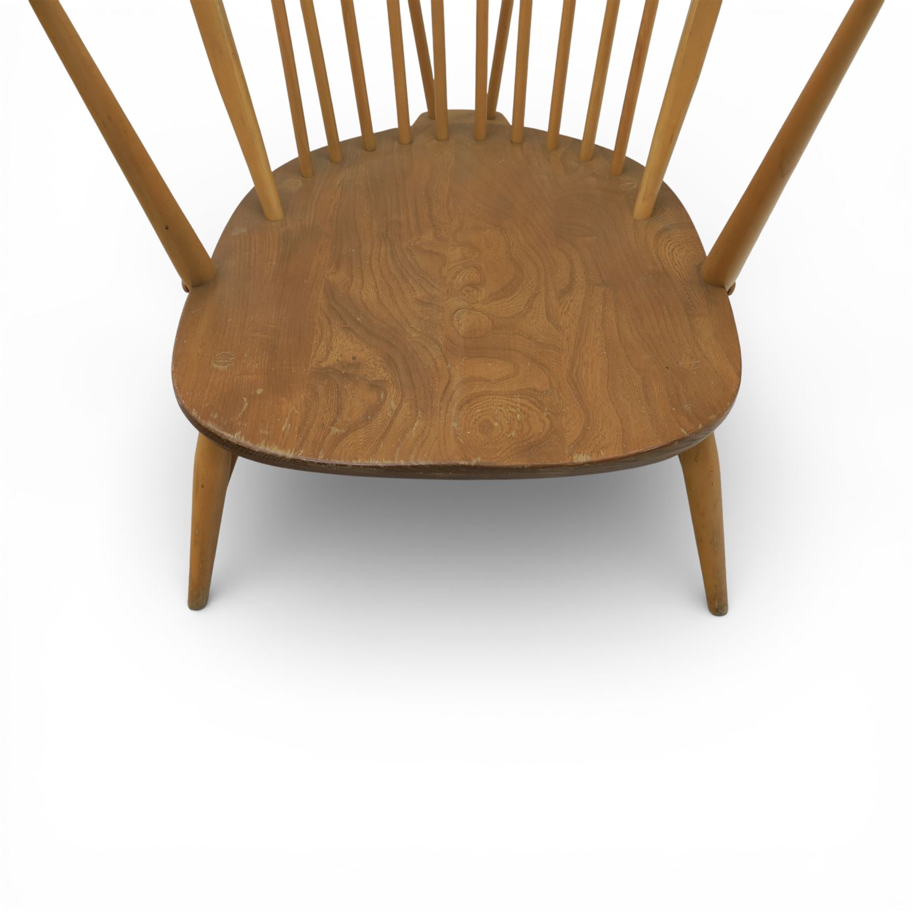 Ercol - Mid 20th century elm and beech Windsor armchair, the hooped spindle back over a shaped elm seat, with scroll front armrests on turned supports, raised on splayed tapering legs united by stretchers, lacking loose seat cushion