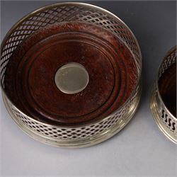 Two silver mounted bottle coasters, the larger example with latticework sides, hallmarked Mappin & Webb Ltd, Birmingham 1993, the smaller example with pierced sides, hallmarked W I Broadway & Co, Birmingham 1998, largest D12cm